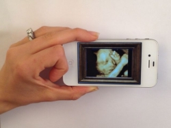 <img src="sonogram on cell phone" alt="sonogram of baby on cell phone">