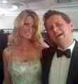 NICKY IN LINDKA CIERACH COUTURE WITH MIKE BUSHELL OF THE BBC AT A JAMES BOND FASHION SHOW Image