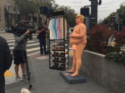 Group is Setting Up Clothes Racks Next to Naked Donald Trump Statues