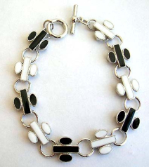 Fashion bracelet in multi enamel black and white flying jet pattern design, with toggle jewelry clas