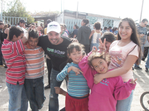 Photo: Açai Roots Co-Founder Marco Rega with children during the event on Saturday.