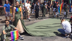 Uriel Saenz with model Ariana Sanchez wearing the "Resist Dress"