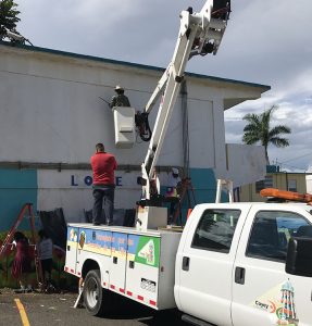 Alexey Steele working on "Love My Meighbor" - "Ama A Tu Vecino" mural in Cayey, Puerto Rico.