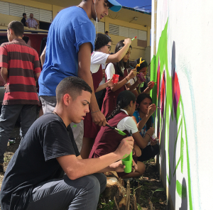 Students from Benjamin Harrison Vocational High School of Cayey participating in mural painting.
