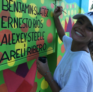 Areli Ribero of Bolivia works on the "Love My Neighbor" - "Ama A Tu Vecino" mural in Cayey, Puerto Rico.