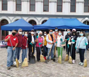 Volunteers clean streets at Los Angeles City Hall's Grand Park