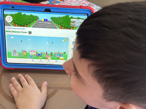 Child Exploring The Good Eggs App – Build Albumen Town Game