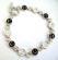 Multi enamel black and white happy face pattern forming fashion bracelet, with toggle jewelry clasp