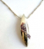 Fashion necklace with beaded chain holding a multi mini purple cz embedded long olive shape metal pe