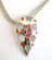 Fashion necklace with double beaded chains holding a multi mini red cz embedded, carved-out pattern