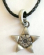 Fashion necklace with black twisted imitation leather string holding a Celtic star metal pendant at