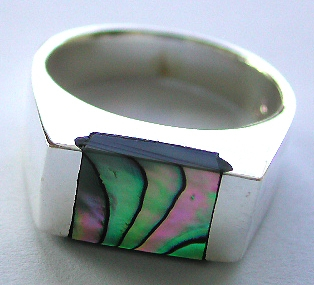 Flat band sterling silver ring with a rectangular shape abalone seashell stone embedded at center