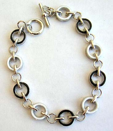 Fashion bracelet in multi enamel black and white circle pattern design, with toggle jewelry clasp fo