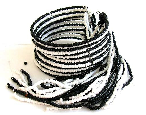 Multi black and white beaded strings forming fashion bracelet bangle with multi beaded string dangle