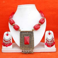 Red simulated stone nuggets set in metal accompanied by chandalier earrings